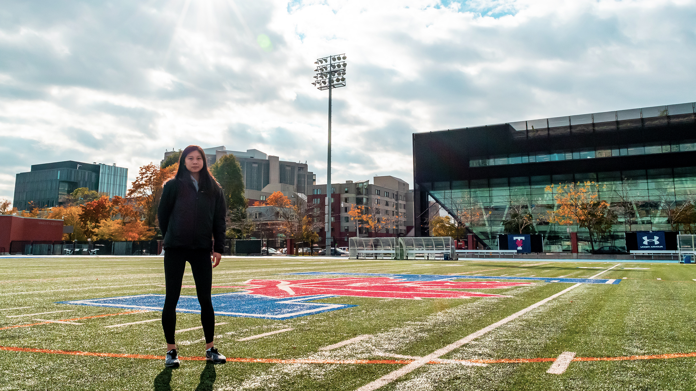 A student stands on the football field